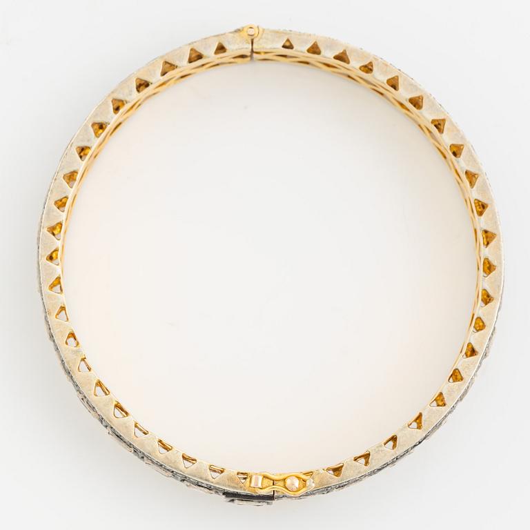 A faceted diamond bangle.