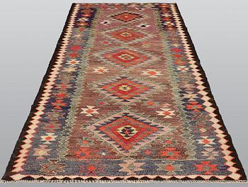 A Kelim rug, c. 253 x 120 cm.