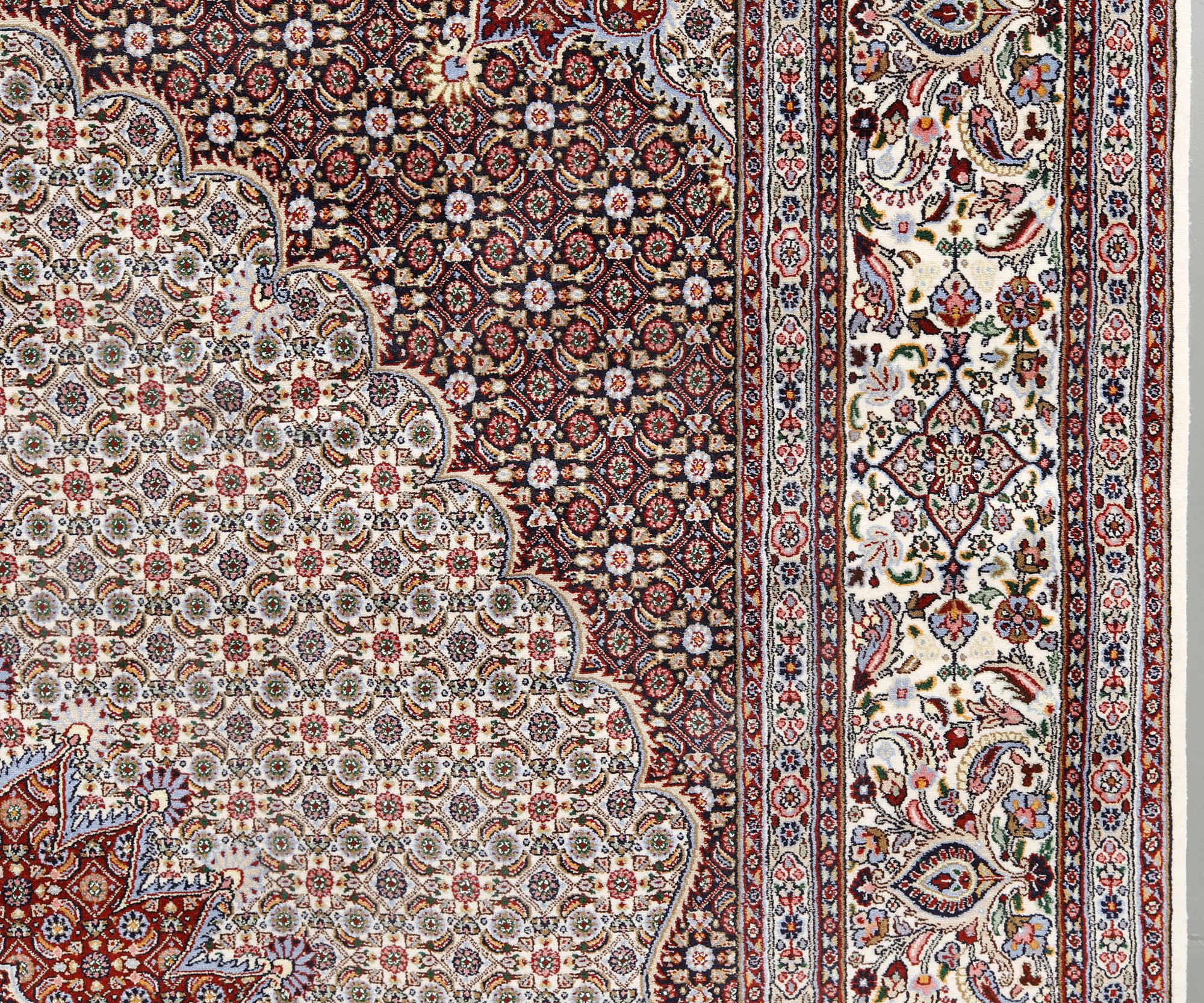 A part silk Moud carpet, approximately 350 x 252 cm.