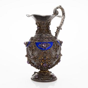 A parcel-gilt silver jug with enamel, and cabochon cut amethysts. First half of the 20th century.