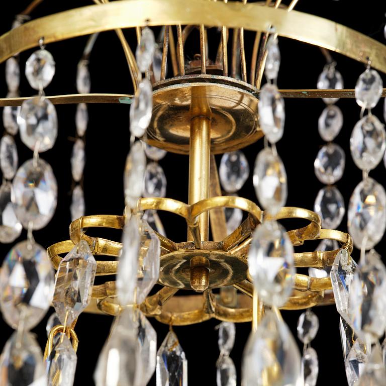 A late Gustavian gilt brass and cut glass four-light chandelier, Stockholm, late 18th century.