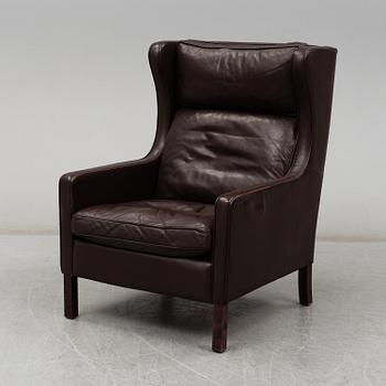 A leather covered 'Lulu' wing-chair from Stouby, Denmark, second half of the 20th Century.