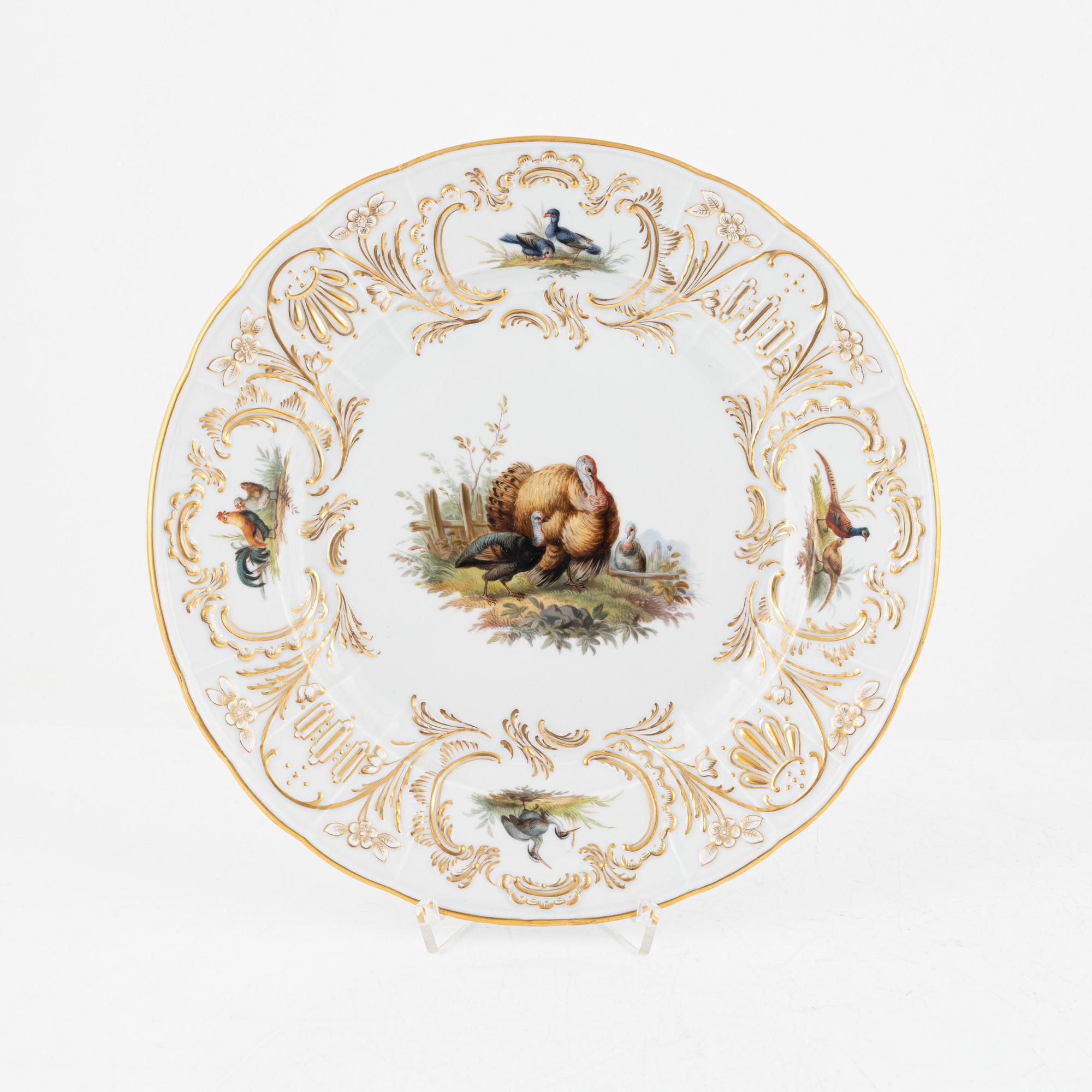 A set of five Meissen porcelain games plates, late 19th to early 20th century.