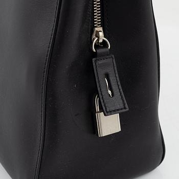 Prada, a black leather bag.