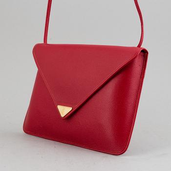 YVES SAINT LAURENT, a red leather bag.