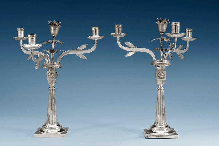 A pair of 18th/19th century silver candelabras, partly Häberlein, Nürnberg 1799-1803, the arms by Carl Friedrich Schönberg, after 1820.