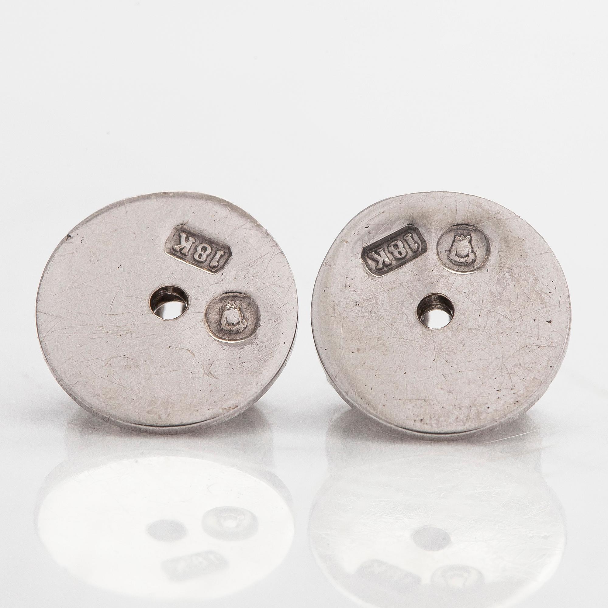 A pair of brilliant-cut diamond stud earrings in 18K white gold.