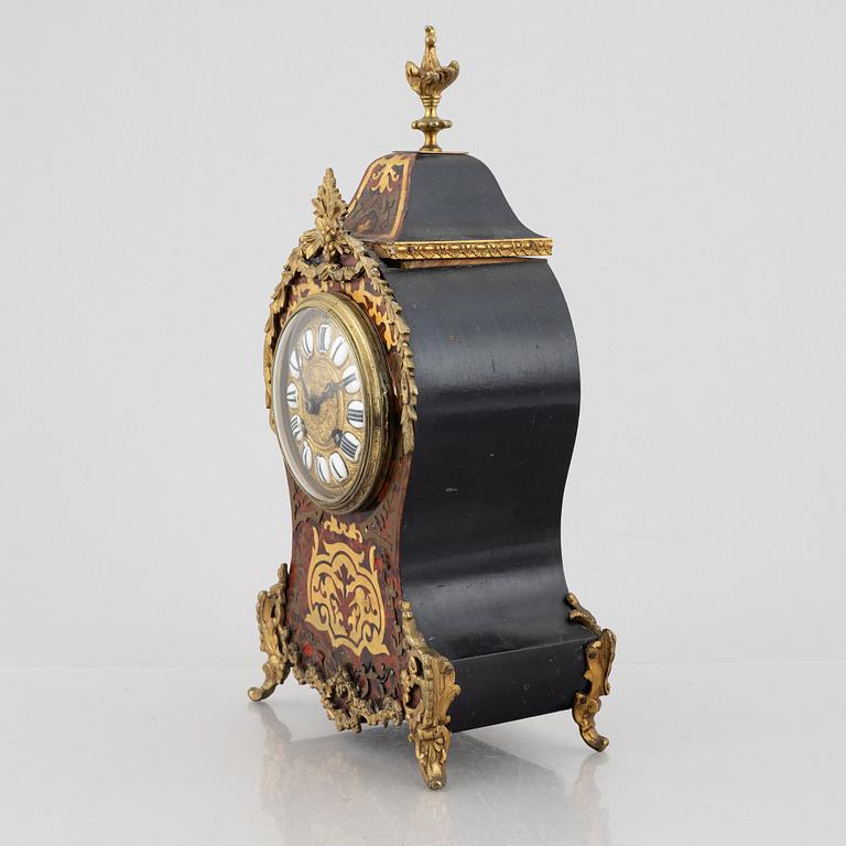 A Louis XV-style mantel clock, late 19th century.