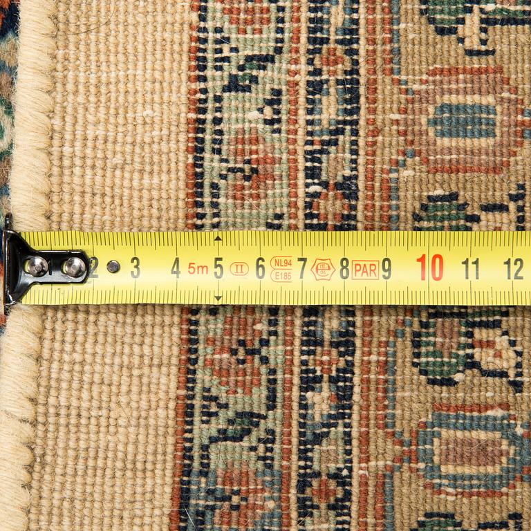 An oriental carpet. Circa 345x245 cm.