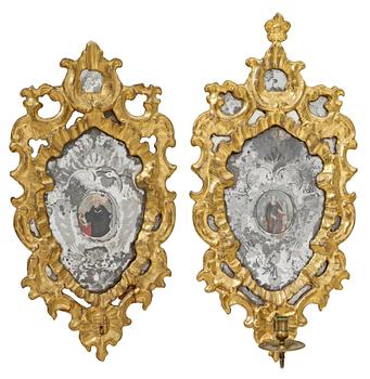 927. A pair of 18th century Italian one-light girandole mirrors (one candle arm missing).