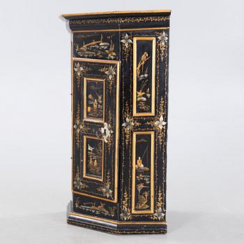 An 18th century corner cabinet.