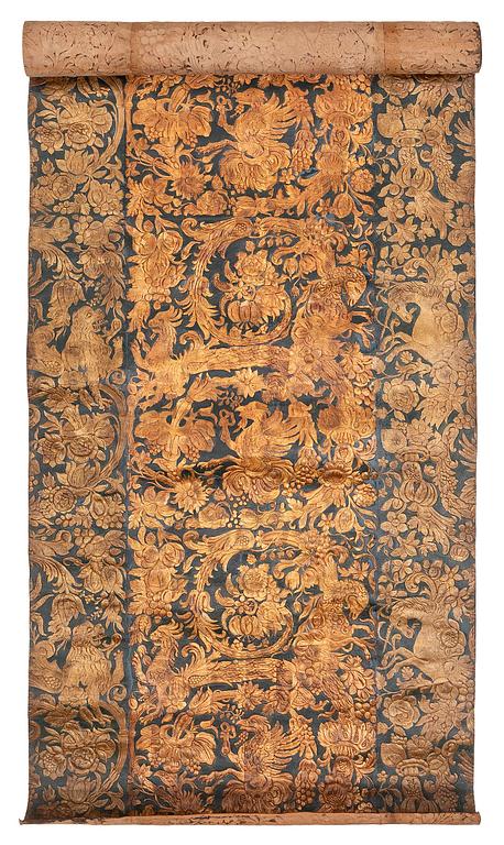 A 19th century wrought leather wallpaper, ca 388 x 97 cm.