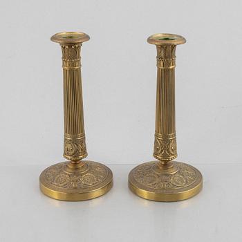 A pair of Empire gilt brass candle sticks, first half of the 20th century.
