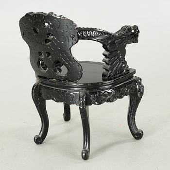 A Japanese 20th century arm chair.