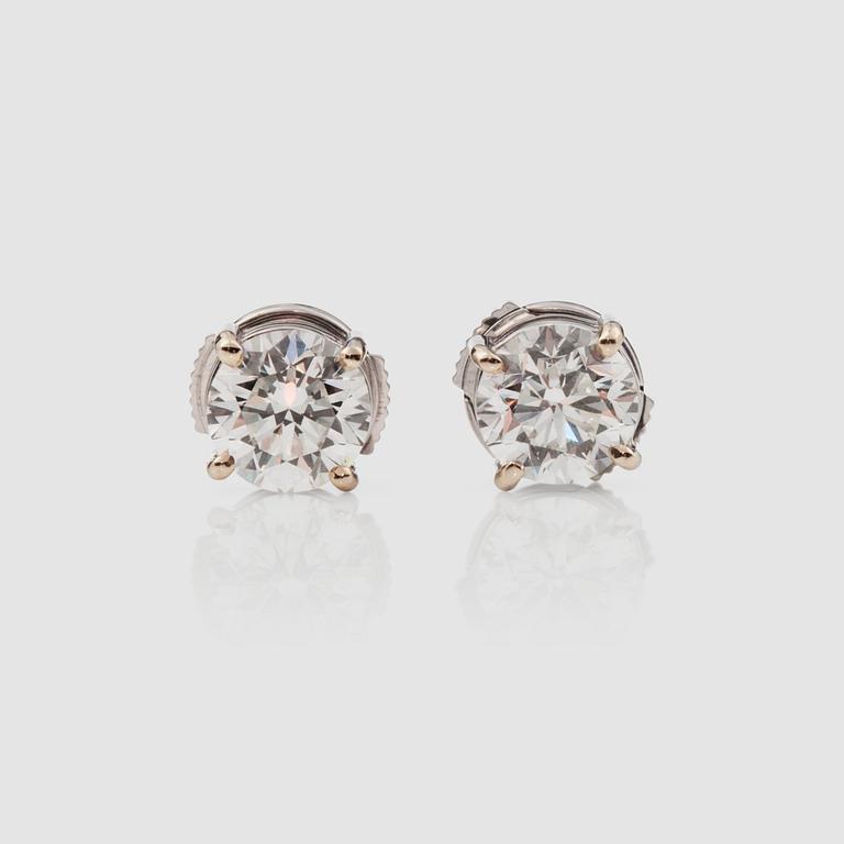 A pair of brilliant-cut diamond solitaire earrings. Total carat weight 2.01 cts.