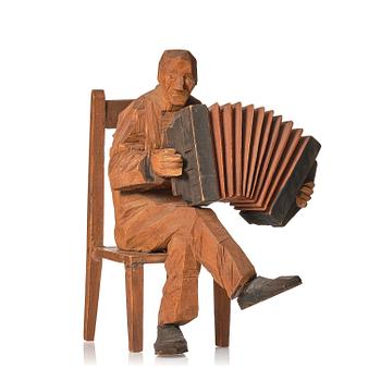 904. Axel Petersson Döderhultarn, Seated accordionist.