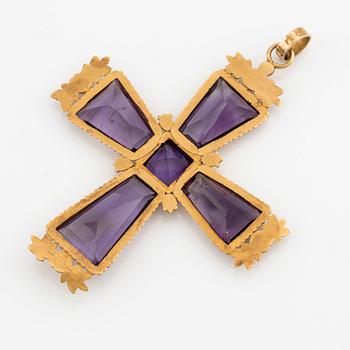 An 18K gold cross with amethysts with a 23K gold chain.
