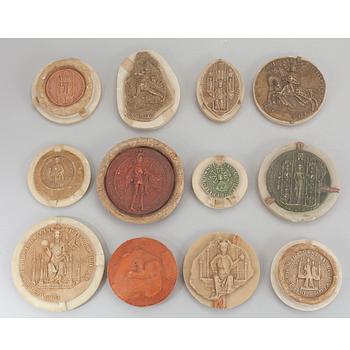 A collection of 12 plaster casts of medieval seals cast by Georg Fleetwood 1930/40s.