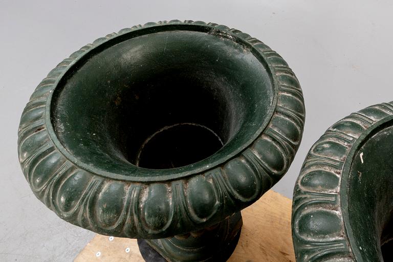 A pair of two 1990s cast iron garden urns.