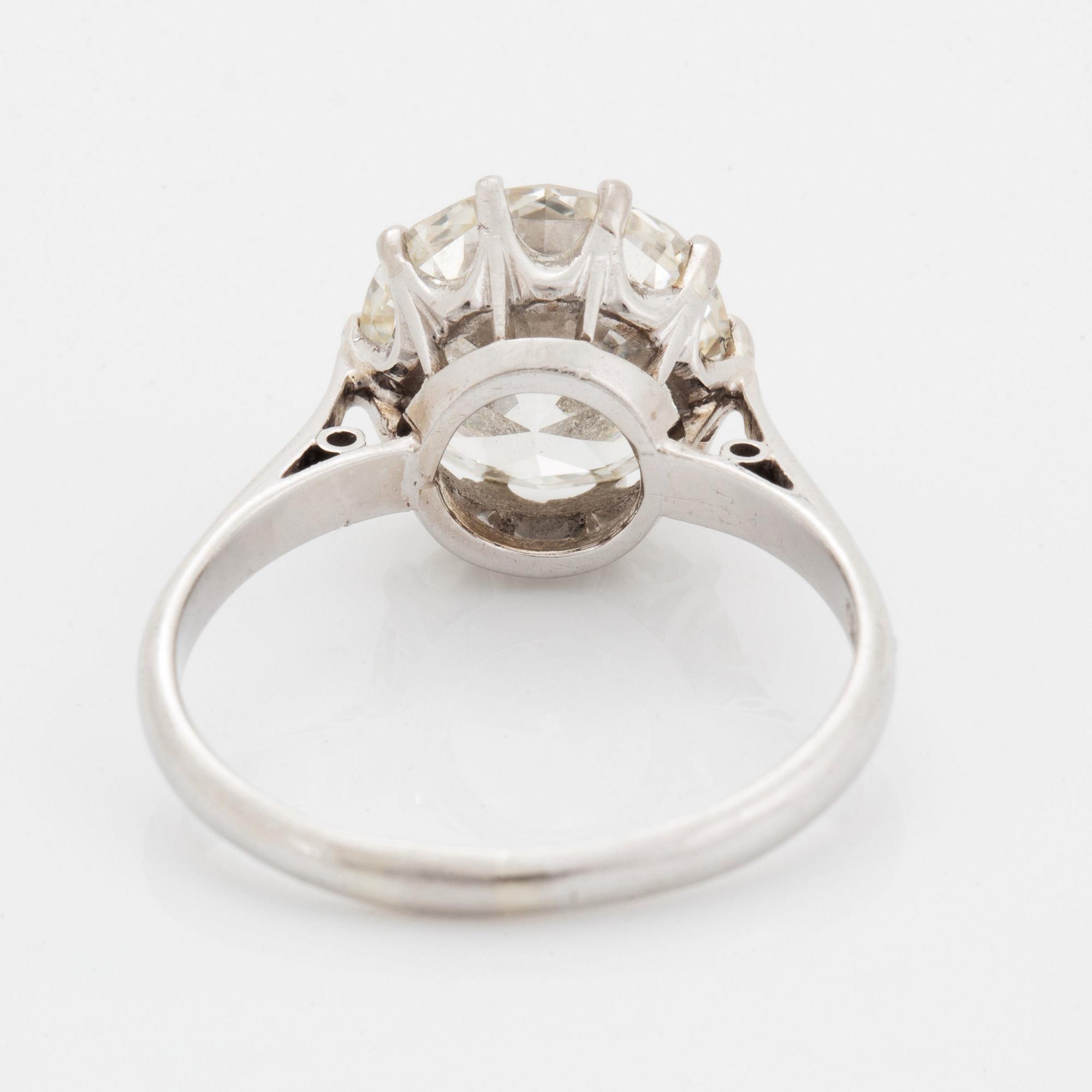 A platinum ring set with an old-cut diamond ca 3.30 cts quality ca J/K vs.