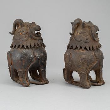 A pair of Chinese iron Fo dogs, 20th Century.