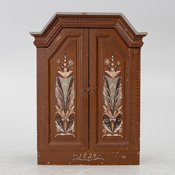 A cabinet, dated 1824.