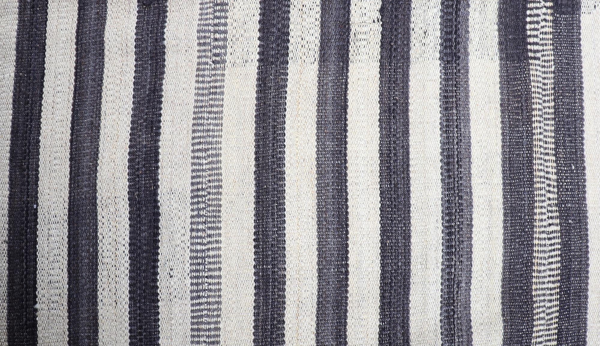 A FLATWEAVE RUG, 292 x 246 cm.