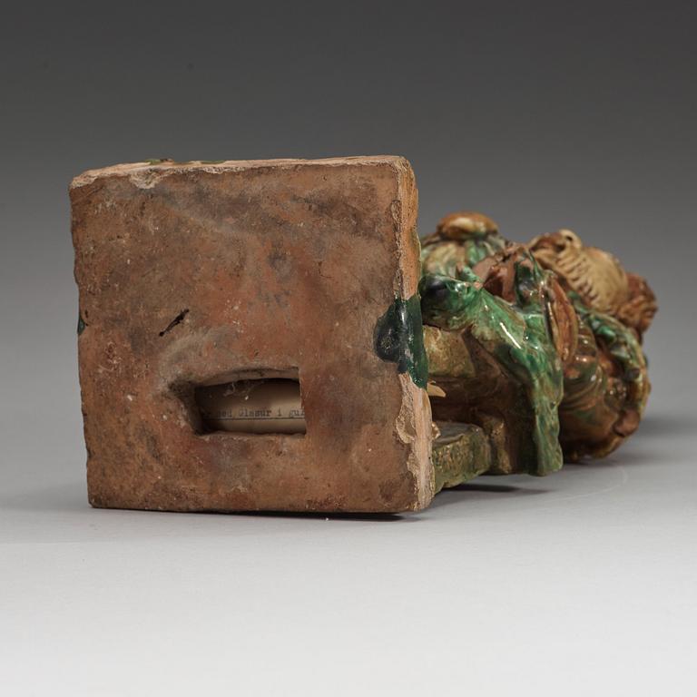 A green and yellow glazed roof tile figure of a warrior, Ming dynasty (1368-1644).