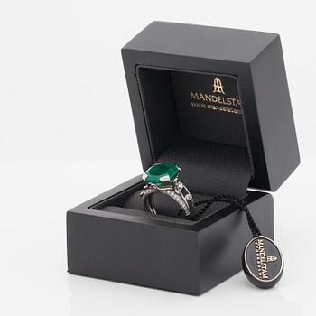 An octagonal cut 6.50 ct emerald and brilliant cut diamond ring. Mandelstam 'Ice Age'.