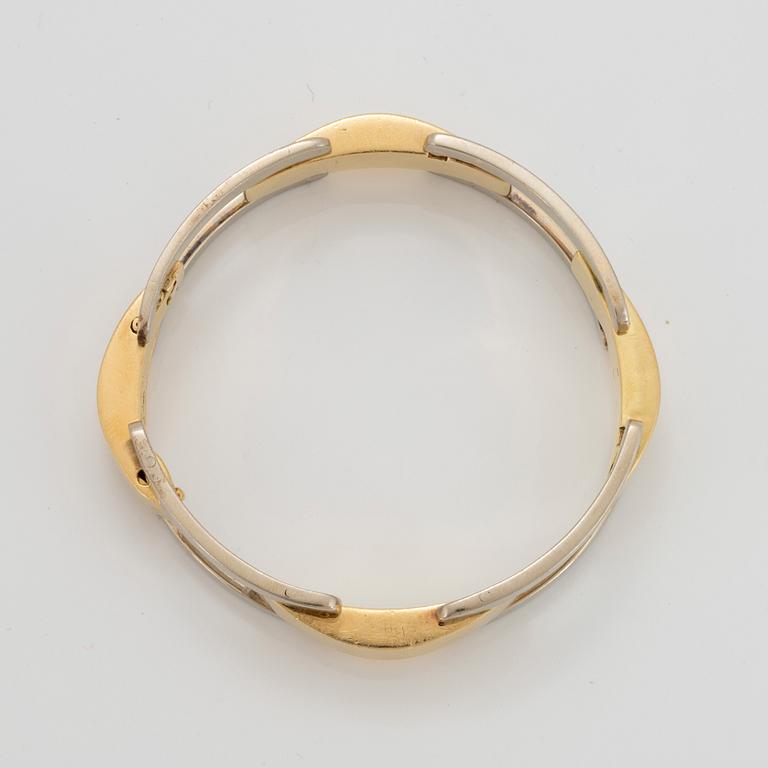 An 18K gold and white gold Cartier bracelet.