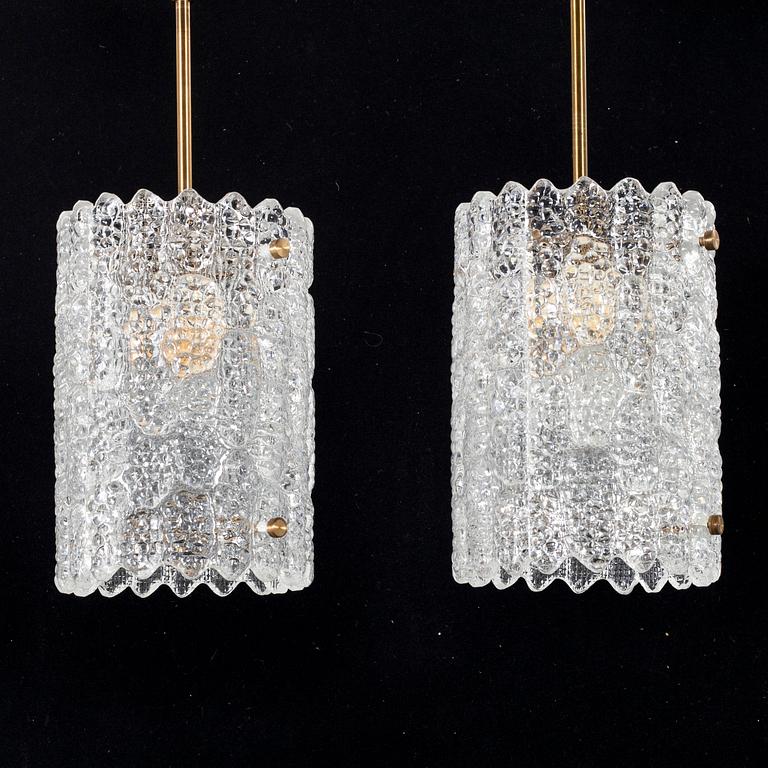 A pair of 20th century brass and glass ceiling lamps by Carl Fagerlund for Orrefors.