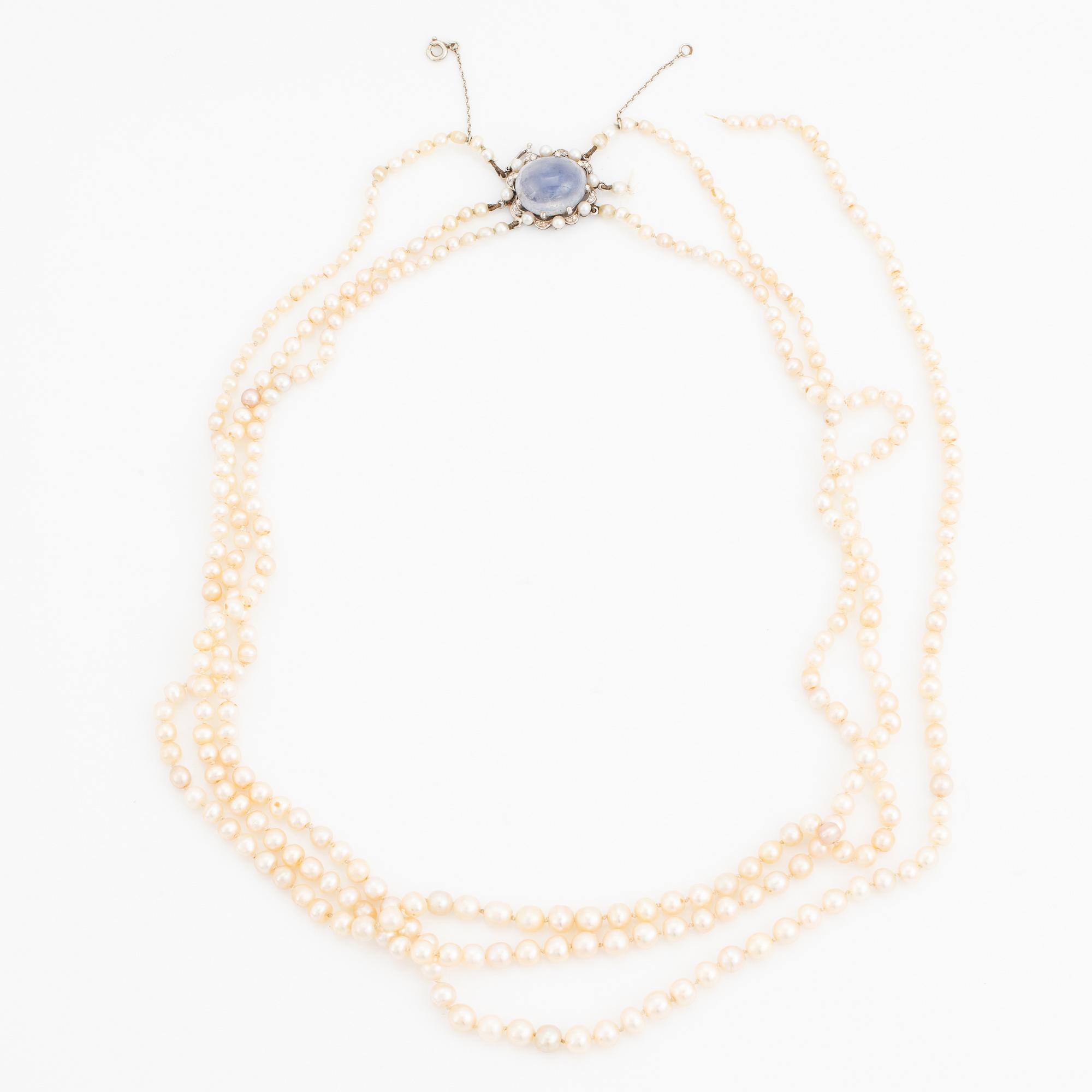 Three strand pearl necklace, clasp with cabochon cut sapphire.