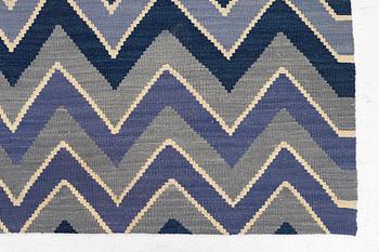 A flat-woven rug, c. 240 x 170 cm.