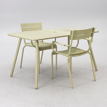Frédéric Sofia, a table and two chairs for outdoor use, "Luxembourg" Fermob, France, 21st century.