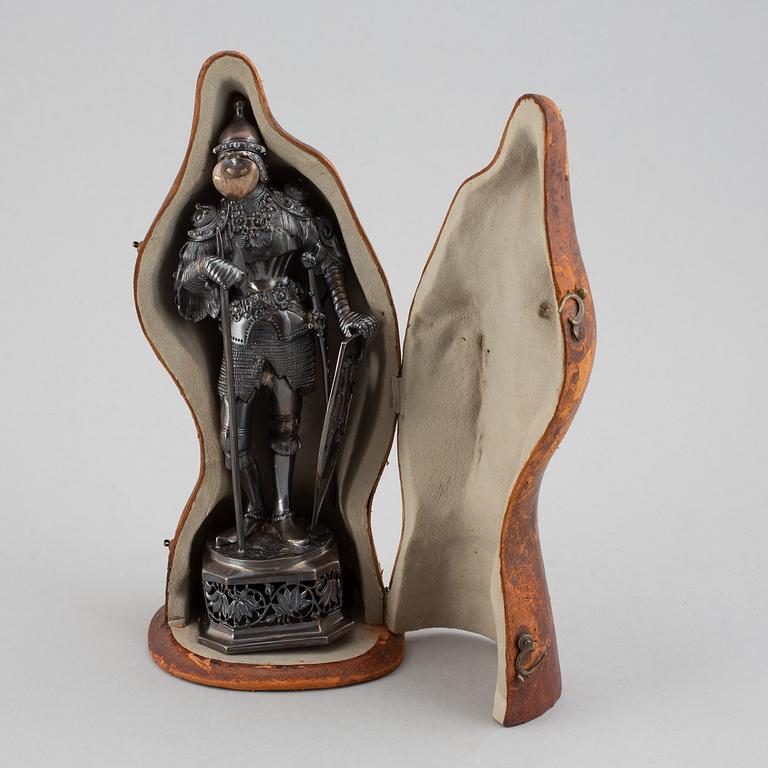 A silver knight figurine in case, pseudo marks.