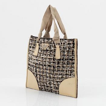 Prada, a tweed and leather bag.