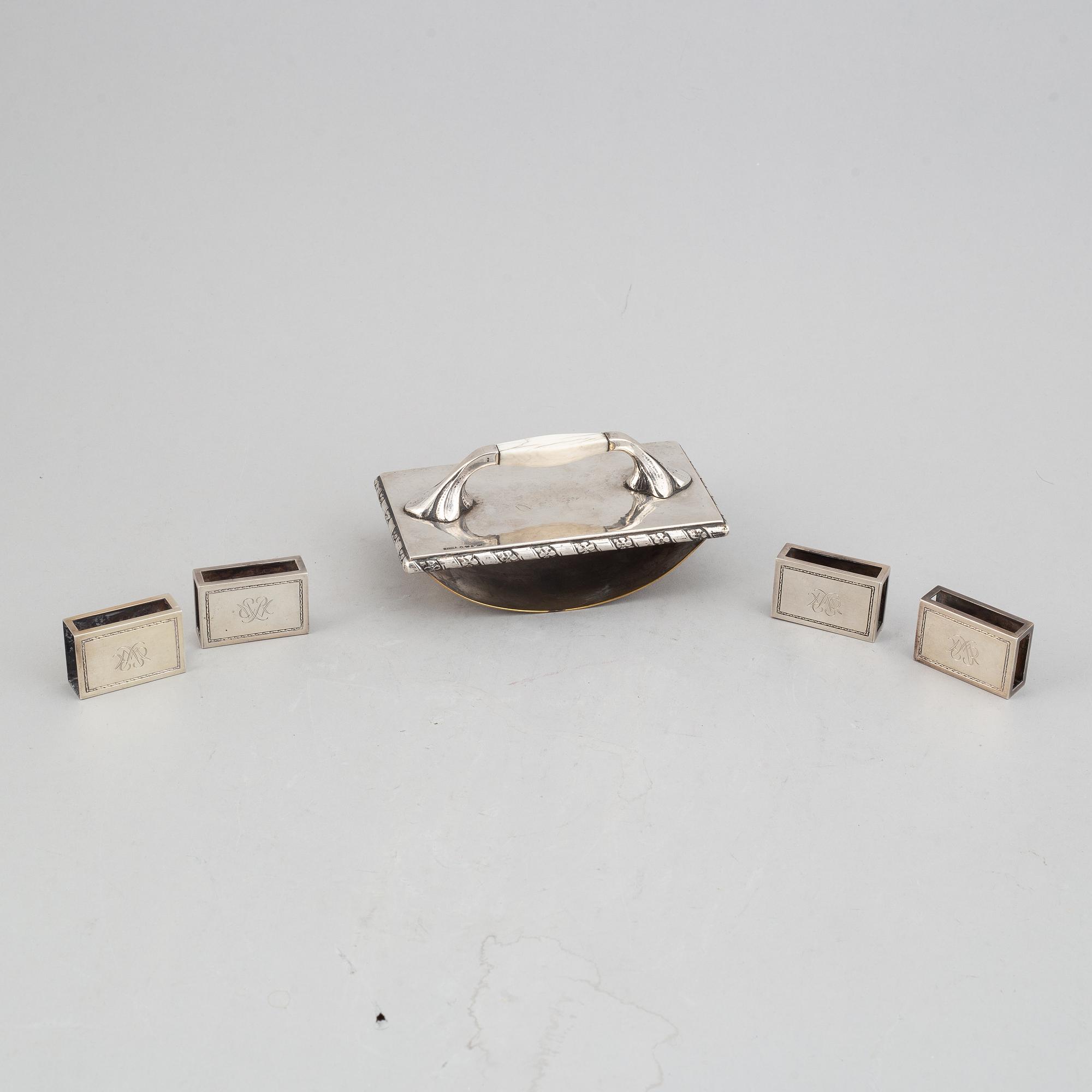 Atelier Borgila, 4 tändsticksfodral samt läskpappersvagga, silver, Stockholm 1922 samt 1939.