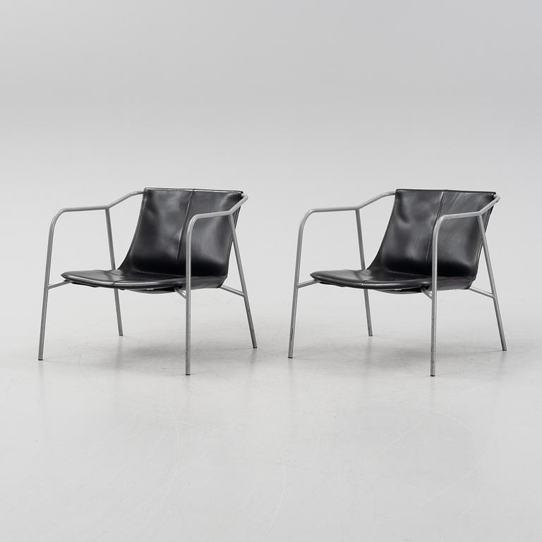 A pair of leather-upholstered easy chairs from Fasem, Italy.