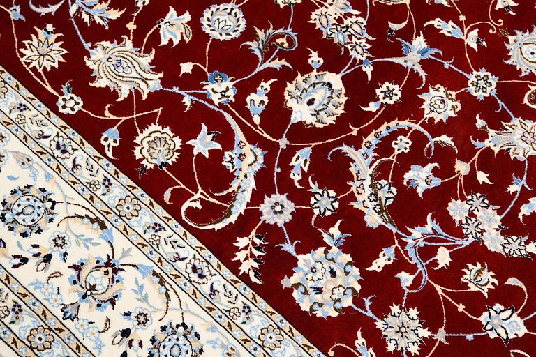 A Nain part silk carpet, 302 x 204 cm.