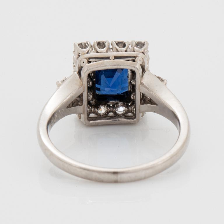 A platinum ring set with a faceted sapphire.