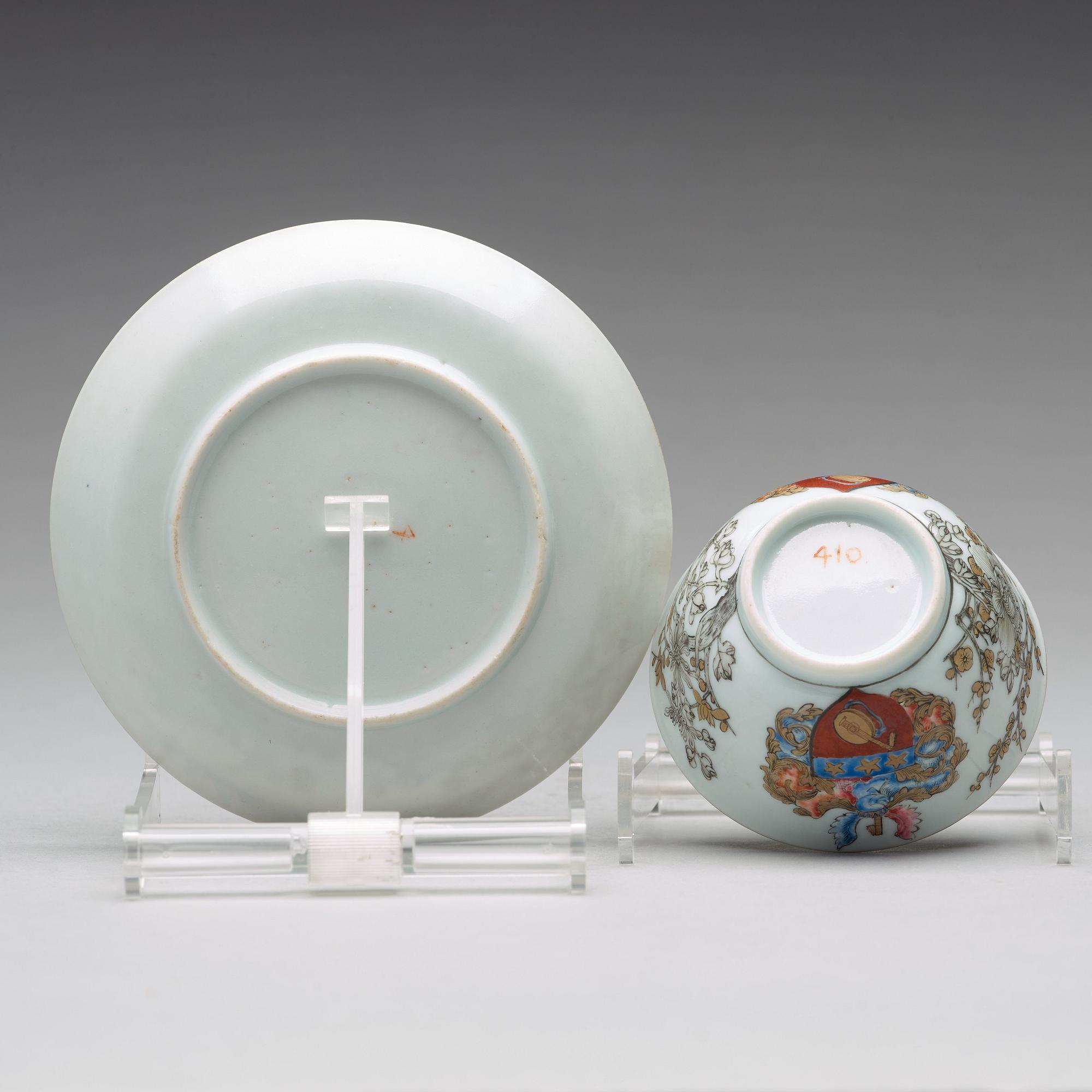 A famille rose armorial cup with saucer, Qing dynasty, 18th Century.