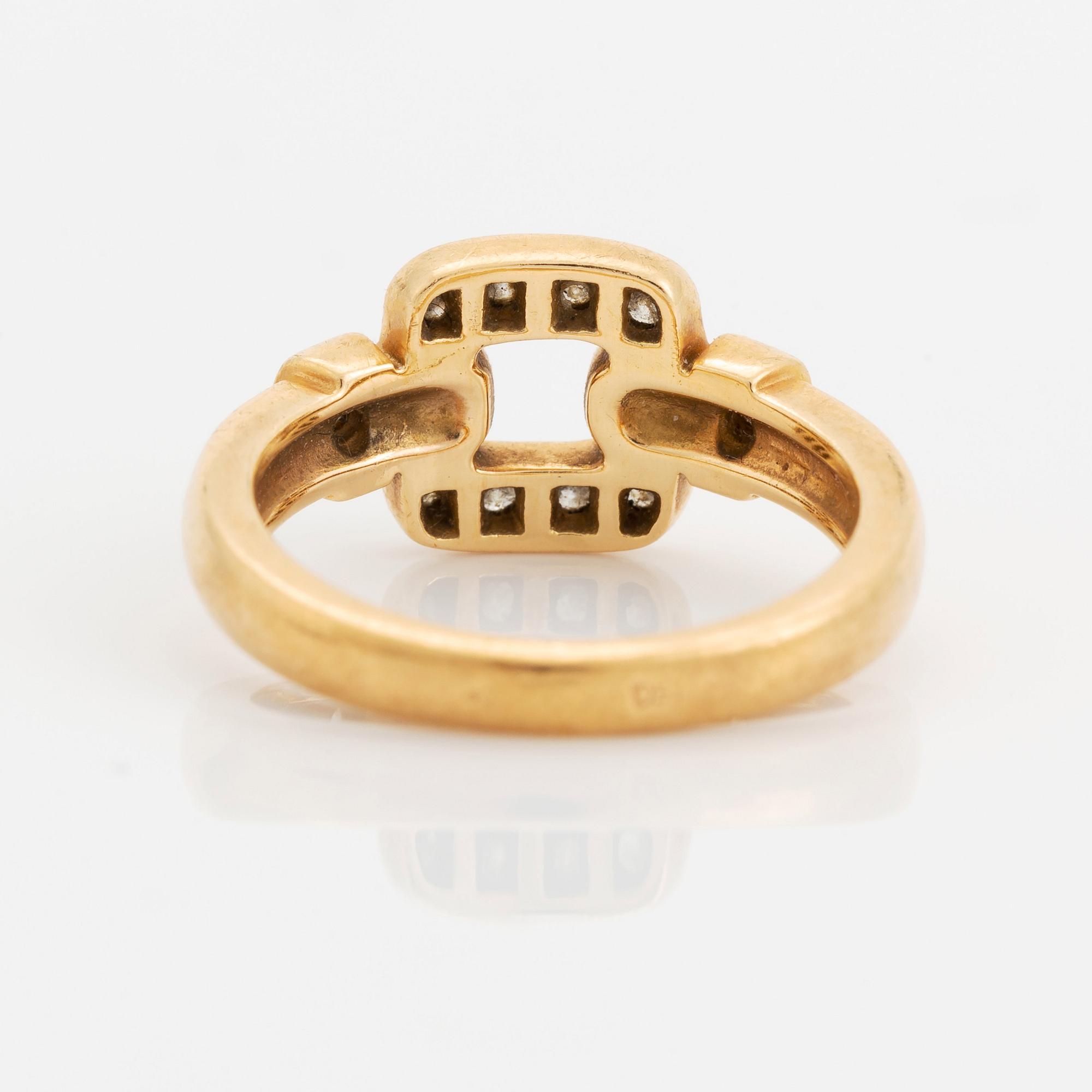 An 18K gold Cartier ring set with round brilliant-cut diamonds.