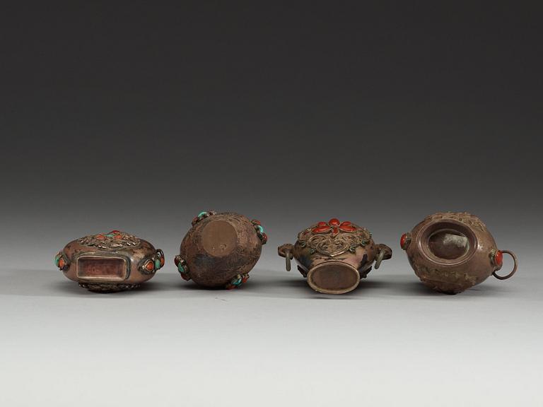 A set of four Tibetan snuff bottles with stoppers, ca 1900.