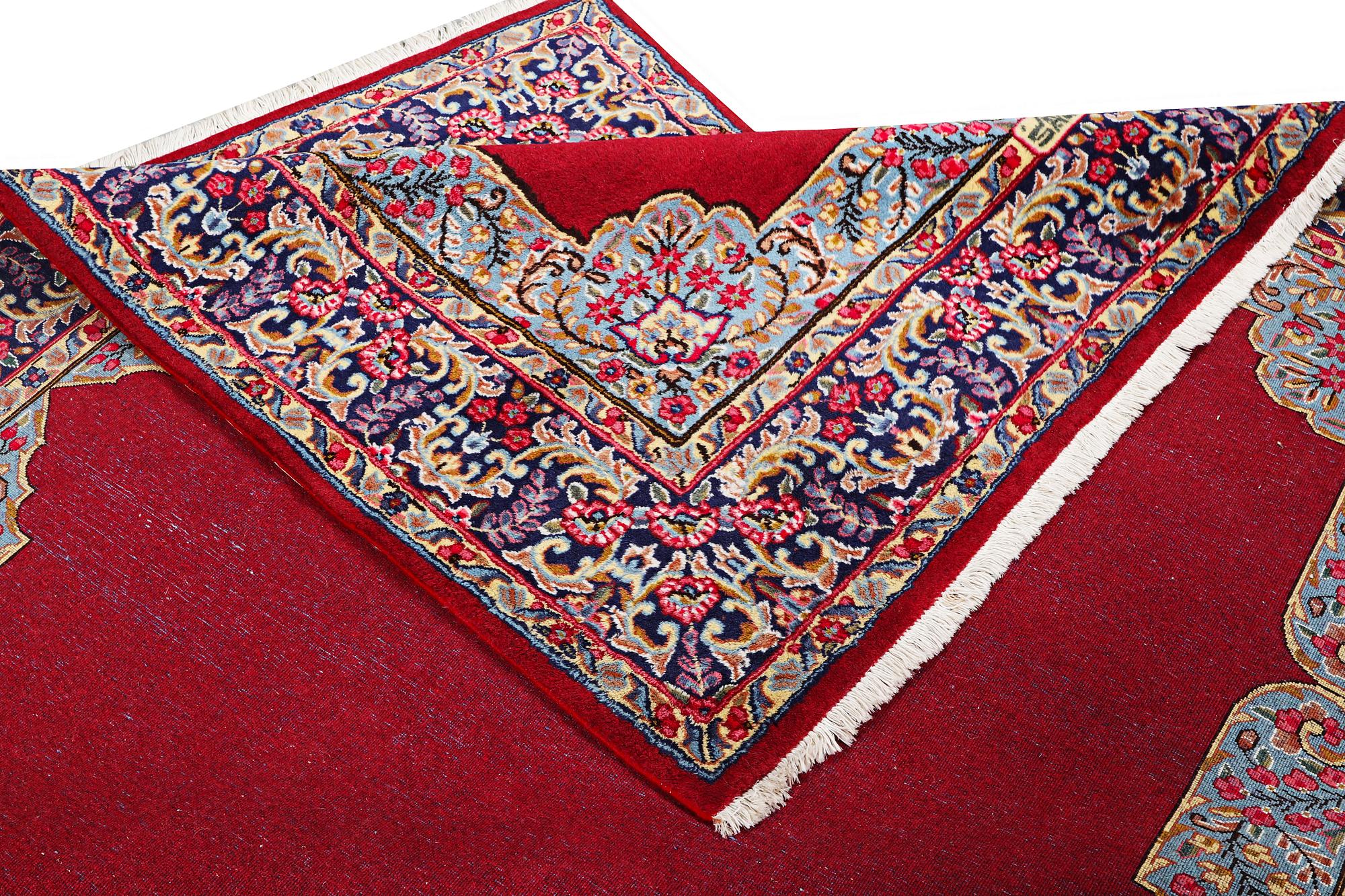 An old Kerman carpet, signed, c. 290 x 208 cm.