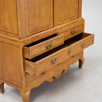 An oak veneered rococo cabinet, mid 18th Century.