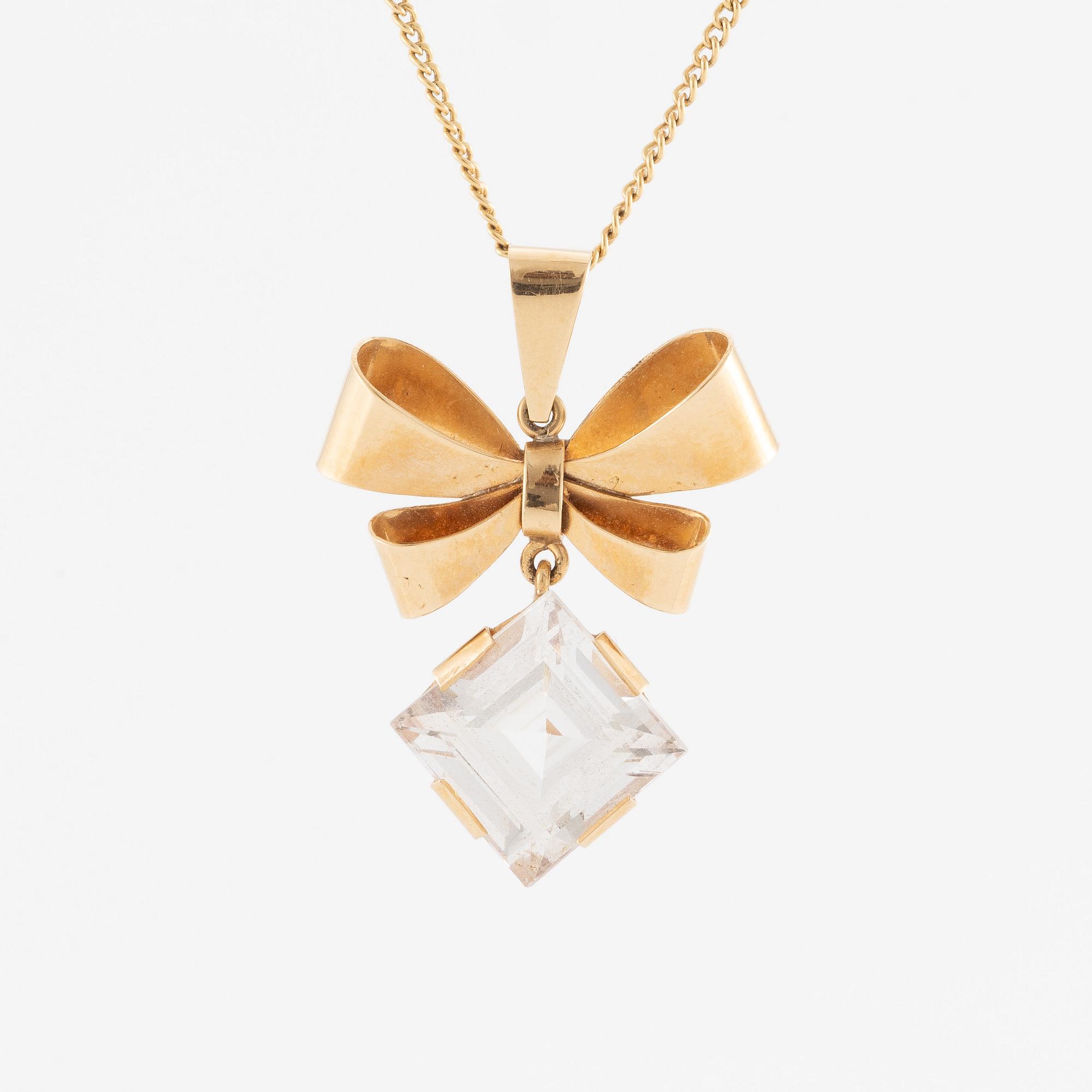 Necklace, 18K gold with synthetic white stone, in the shape of a bow.