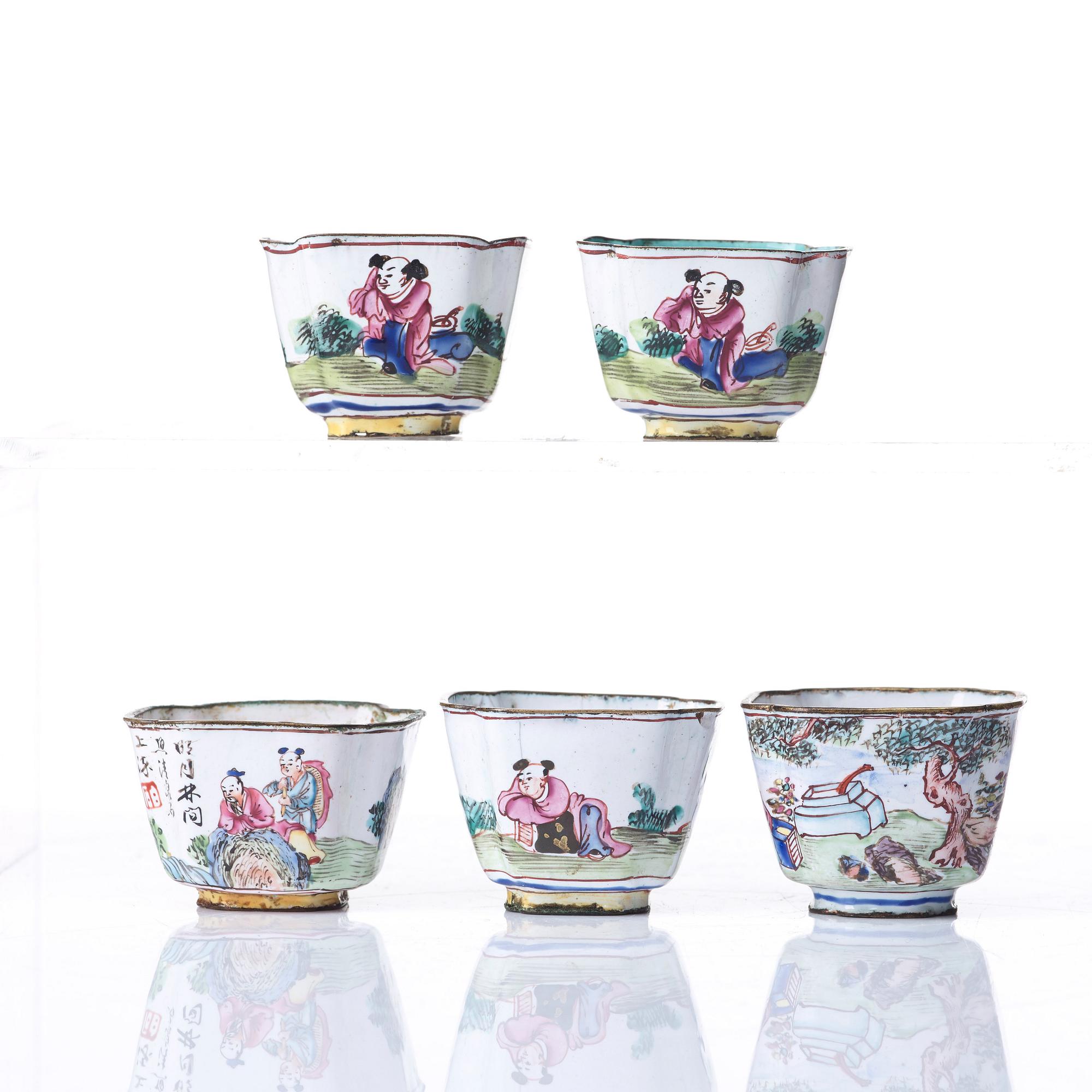 A set of five enamel on copper tea cups and a dish, Qing dynasty, circa 1800.