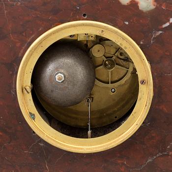 AN EMPIRE ORMOLU AND MARBLE MANTEL CLOCK, first half of the 19th century.