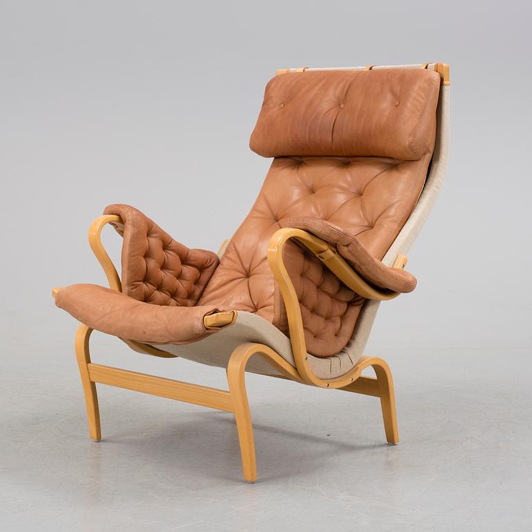 A Bruno Mathsson 'Pernilla' beech, canvas and brown leather easy chair, DUX, Sweden.