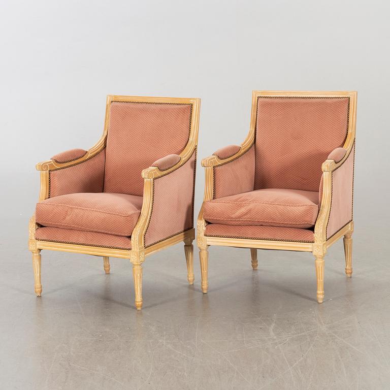 A pair of 20th century gustavian style armchairs.